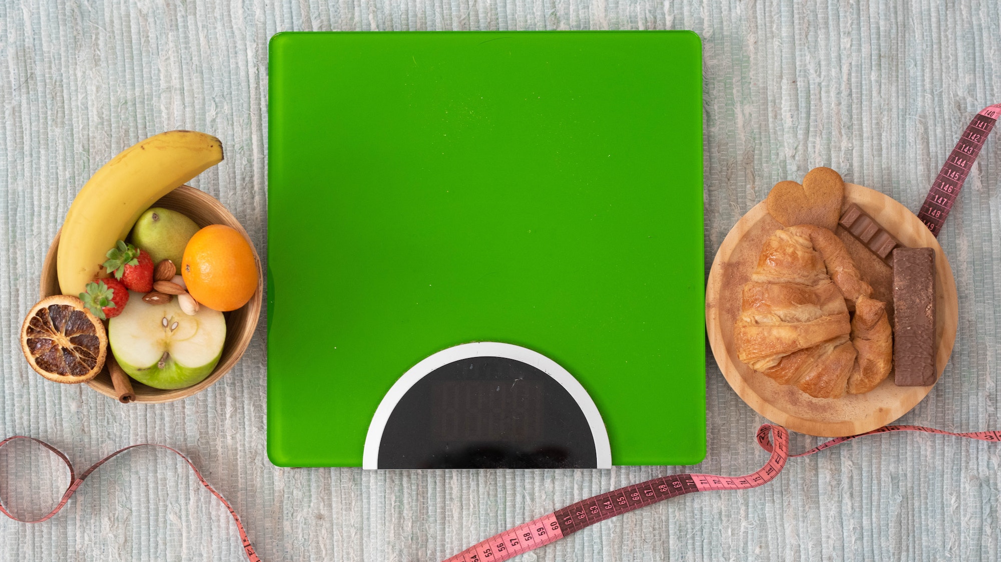 close up and portrait of weight scale on the floor with fruit and healthy food